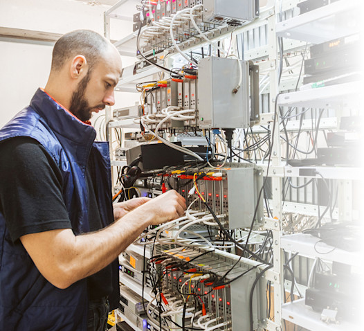 Worker works on the control panel in the data center