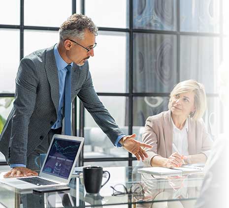 Manager discussing work with his colleagues at a business meeting